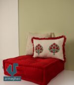 Buying a red sofa and a hand-embroidered cushion